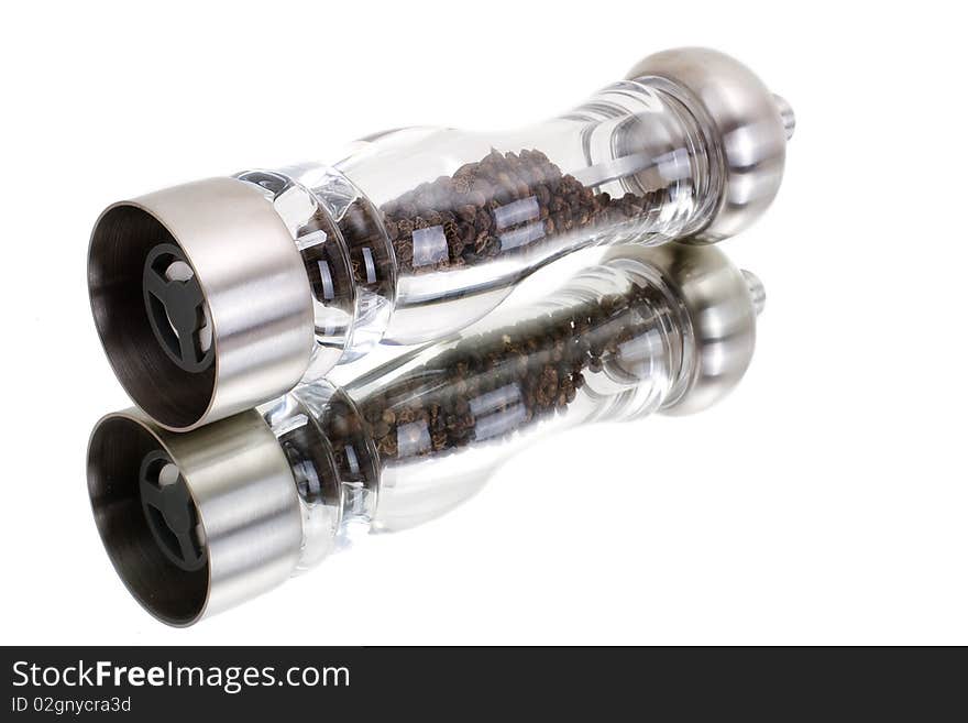 A series. A glass grinder of pepper isolated on a white background. A series. A glass grinder of pepper isolated on a white background