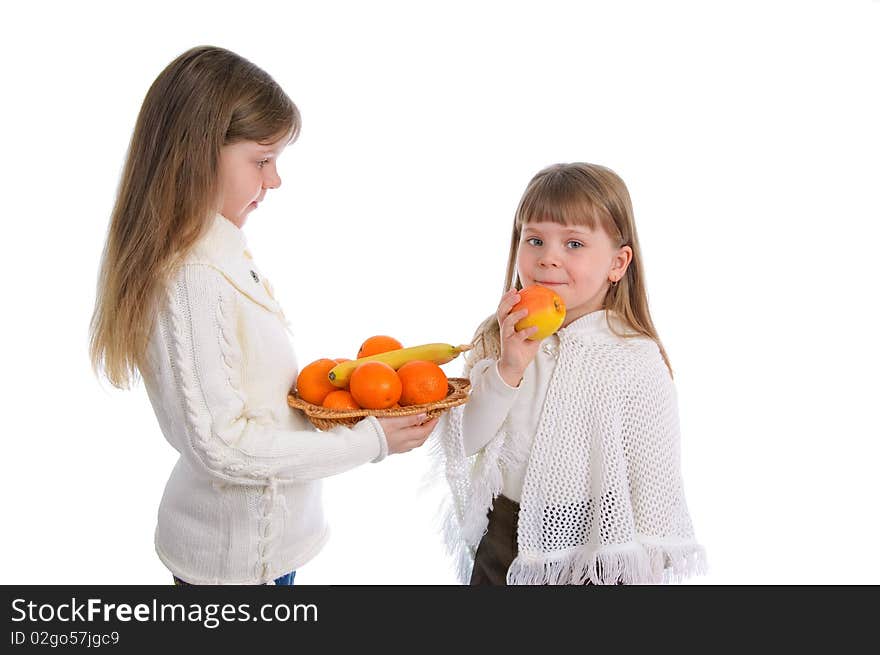 Two cheerful little girls with fruits