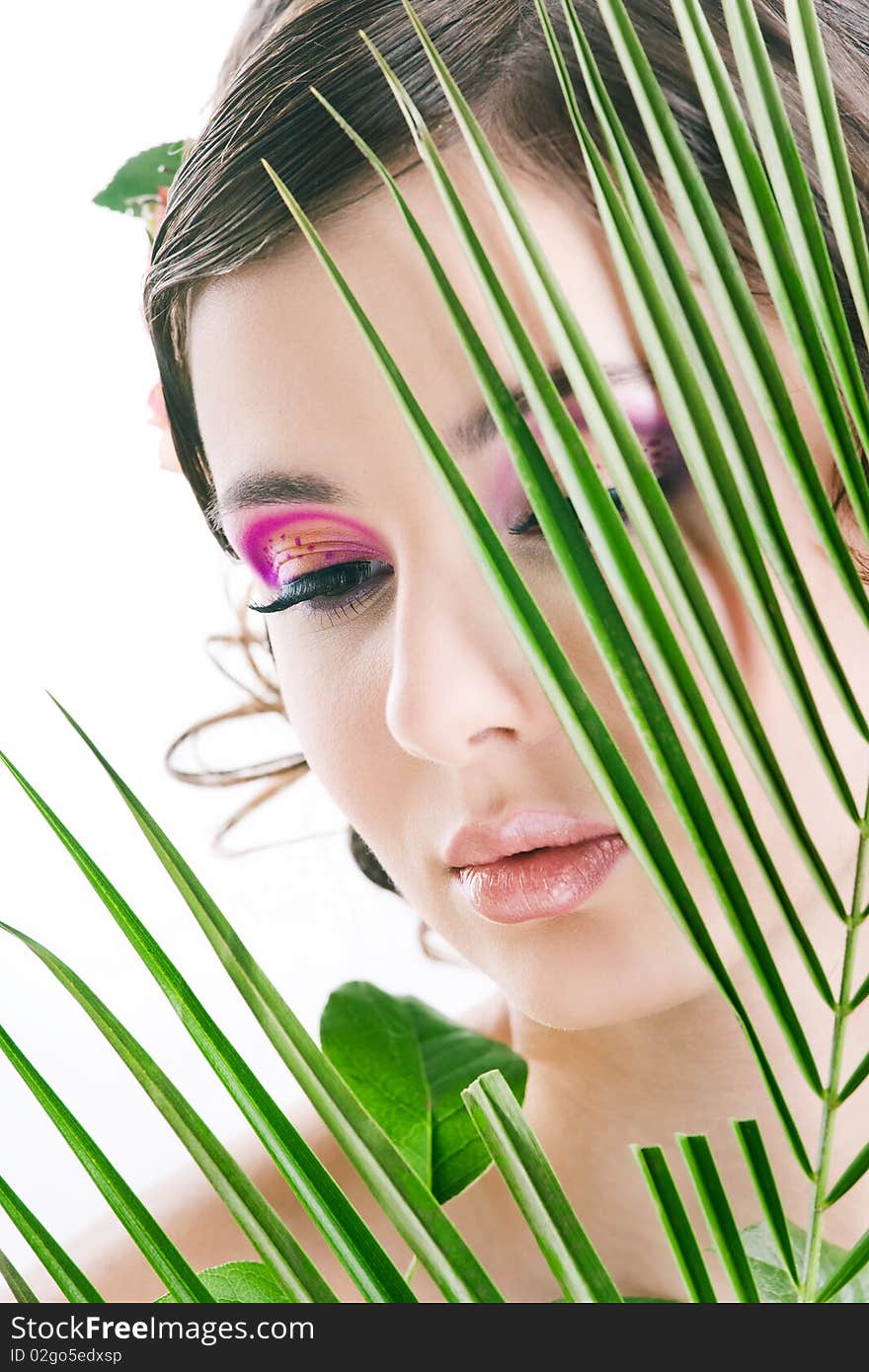 Young pretty girl with green leaf