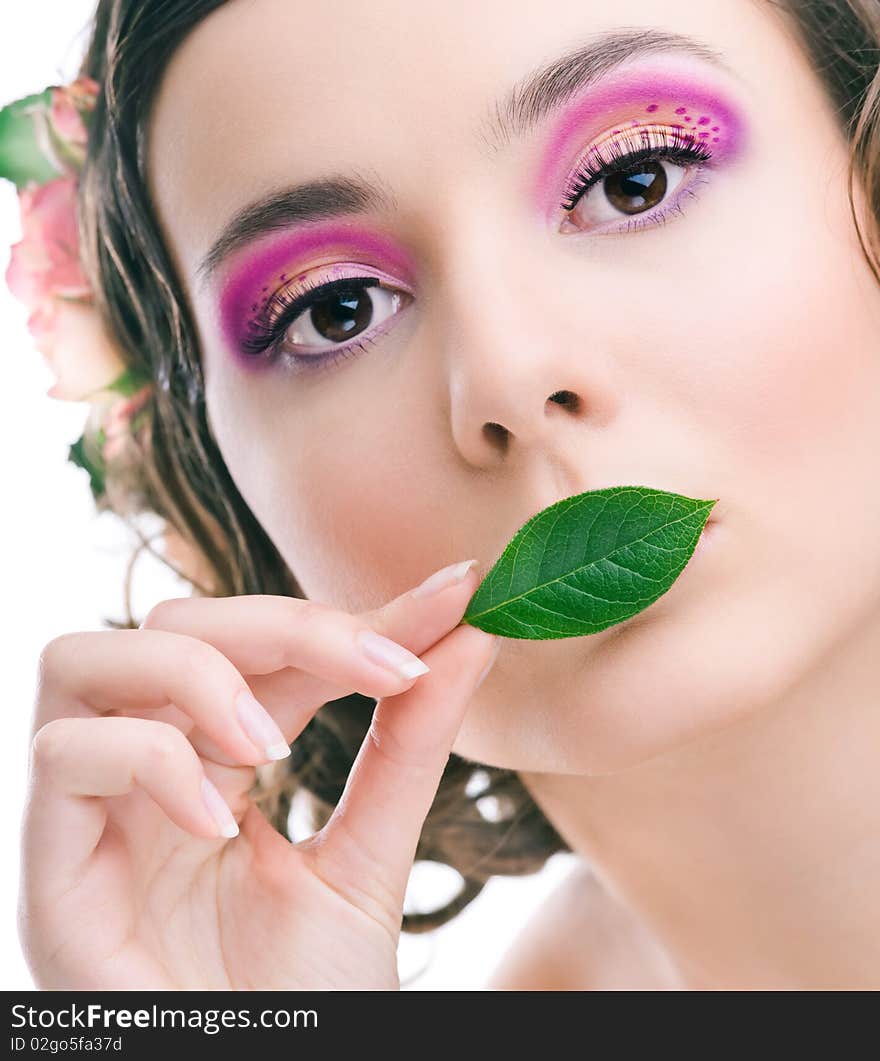 Young pretty girl with green leaf