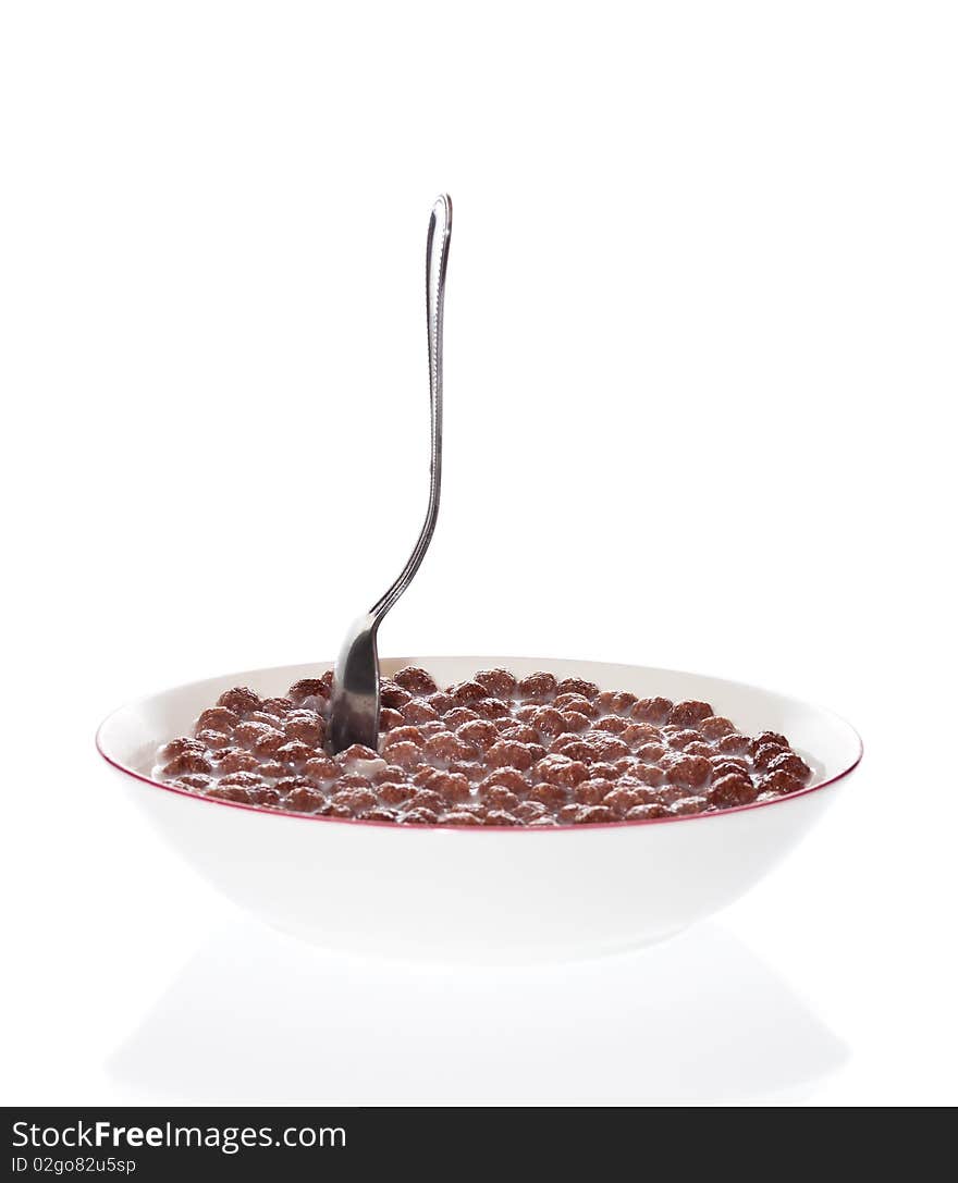 Spoon In A Bowl Of Milk And Chocolate Cereal