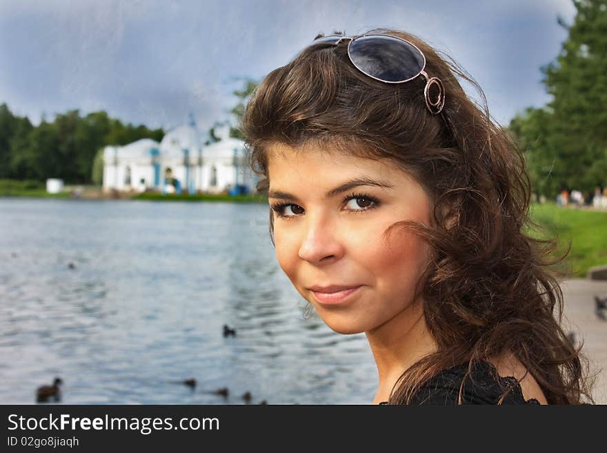 Woman with sunglasses near the pond