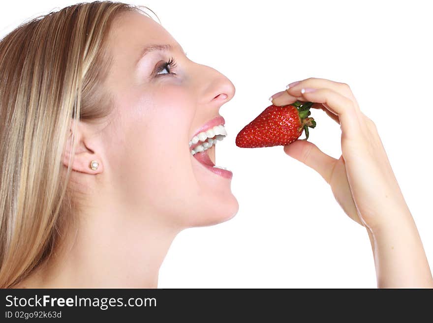 Caucasian blond woman eating strawberry