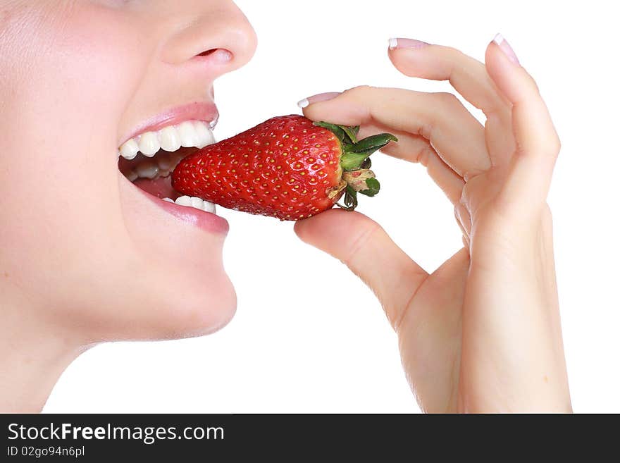 Caucasian blond woman eating strawberry