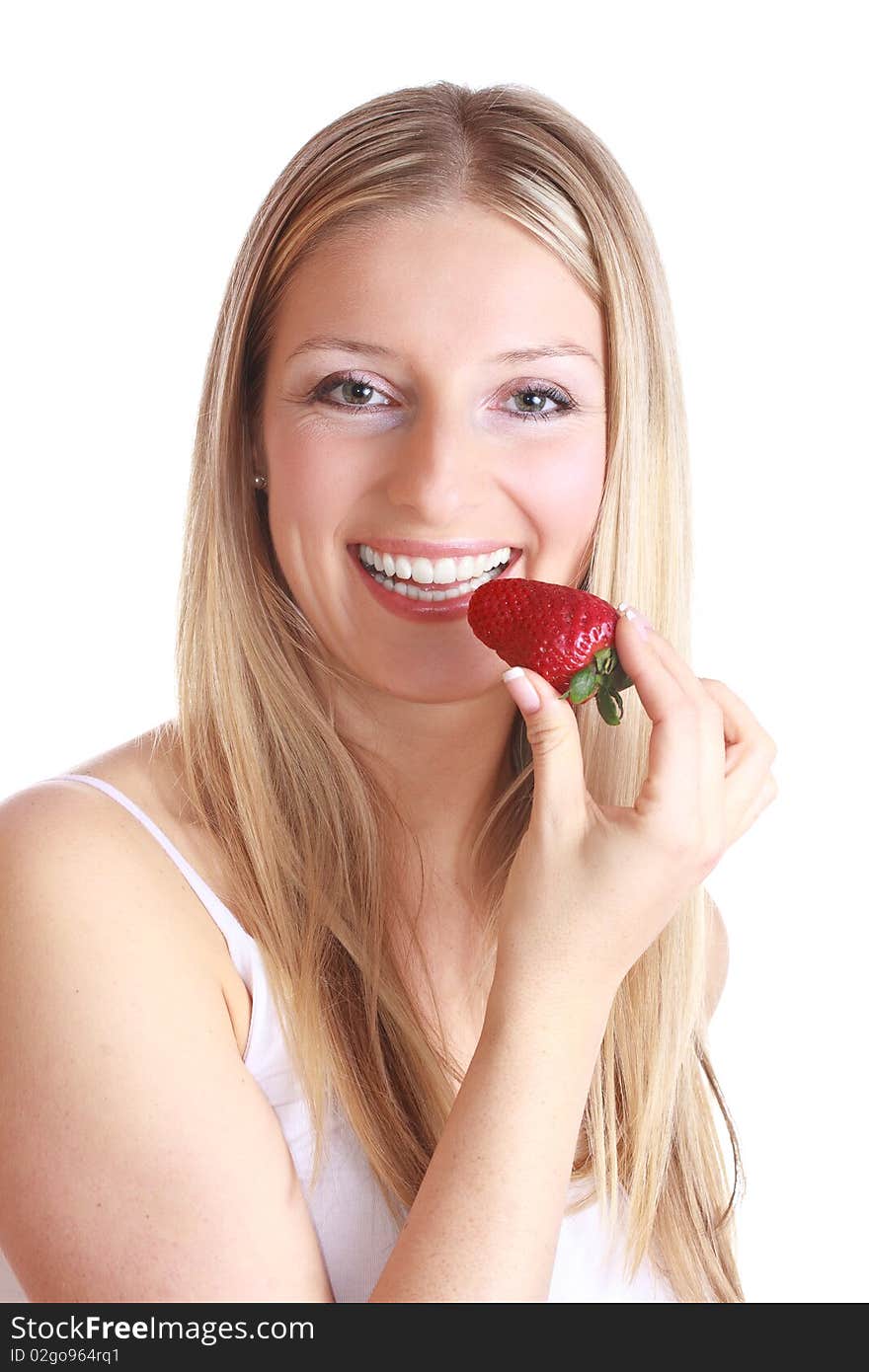 Caucasian blond woman eating strawberry