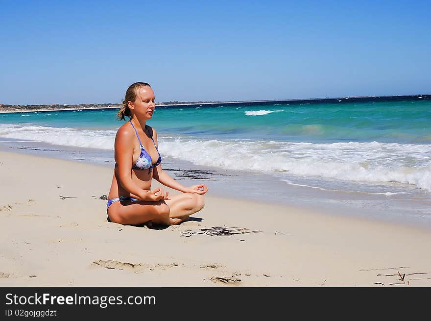 Young beautiful girl on the beach, relax and breathe fresh sea air