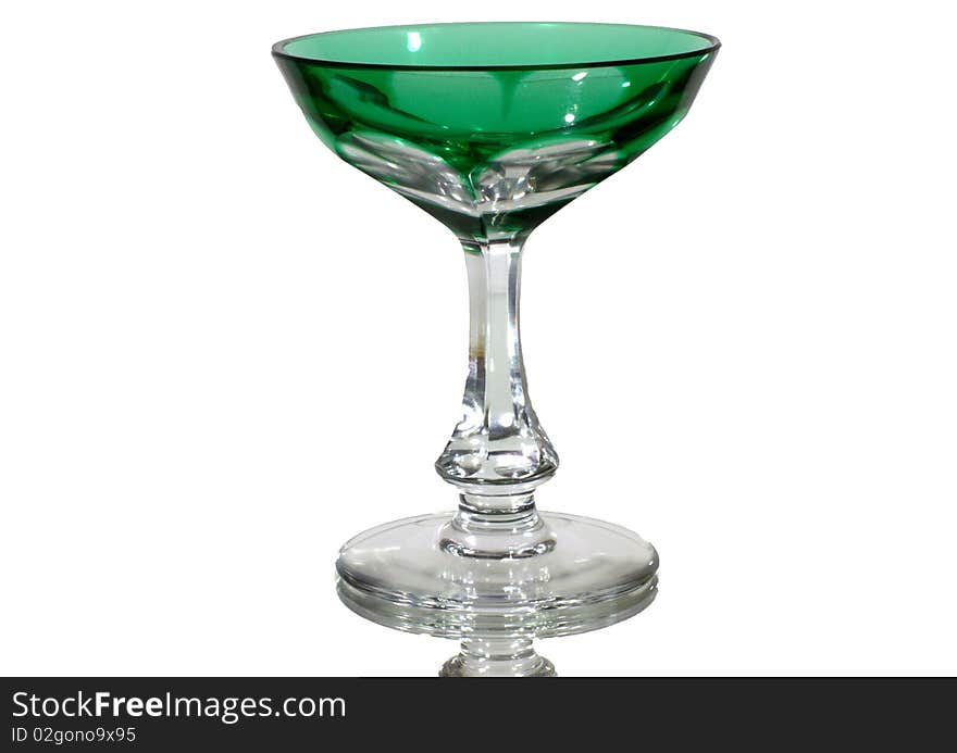 Green cocktail glass on white mirror