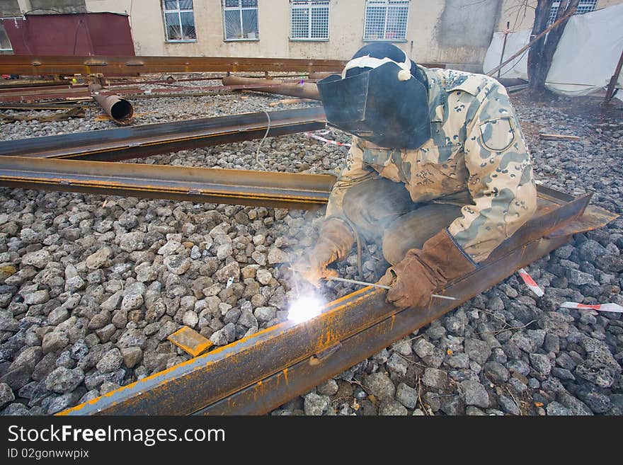 Welder in mask welding construction