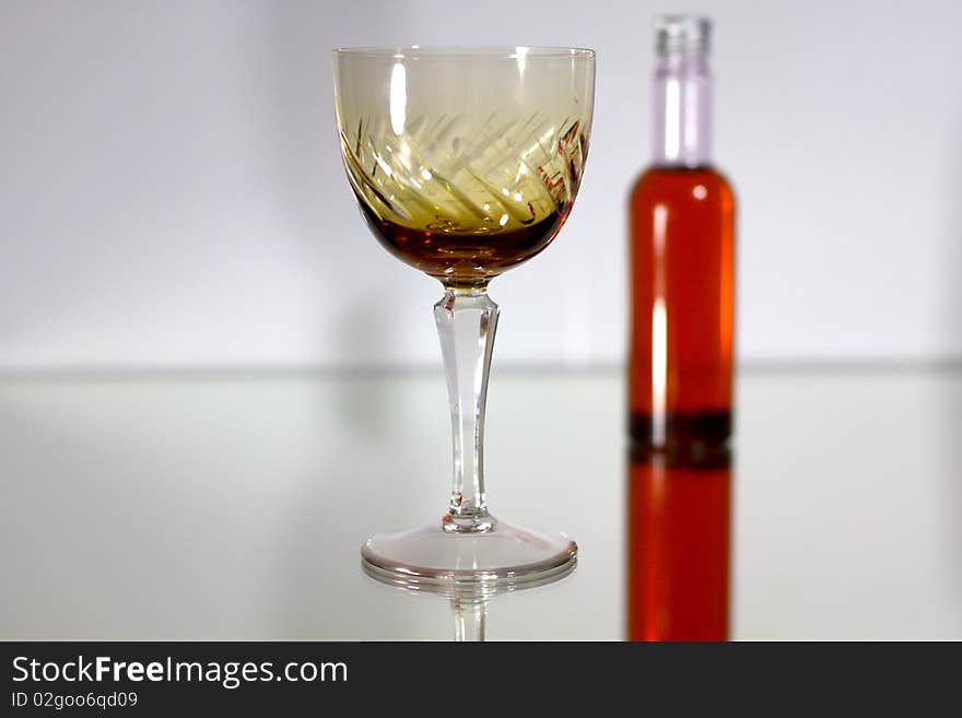 Small liquor bottle and glass. Small liquor bottle and glass