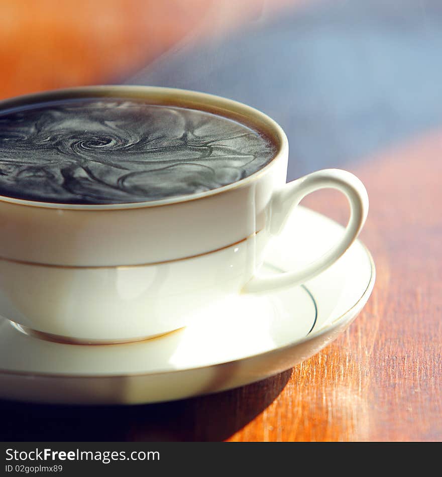 Black coffee. Cup of hot fragrant coffee on a table