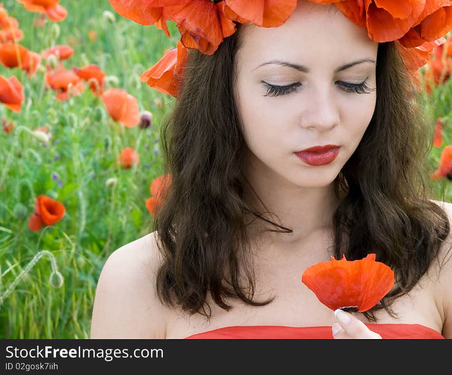 Beautiful girl with long hair posing at poppy meadow. Beautiful girl with long hair posing at poppy meadow