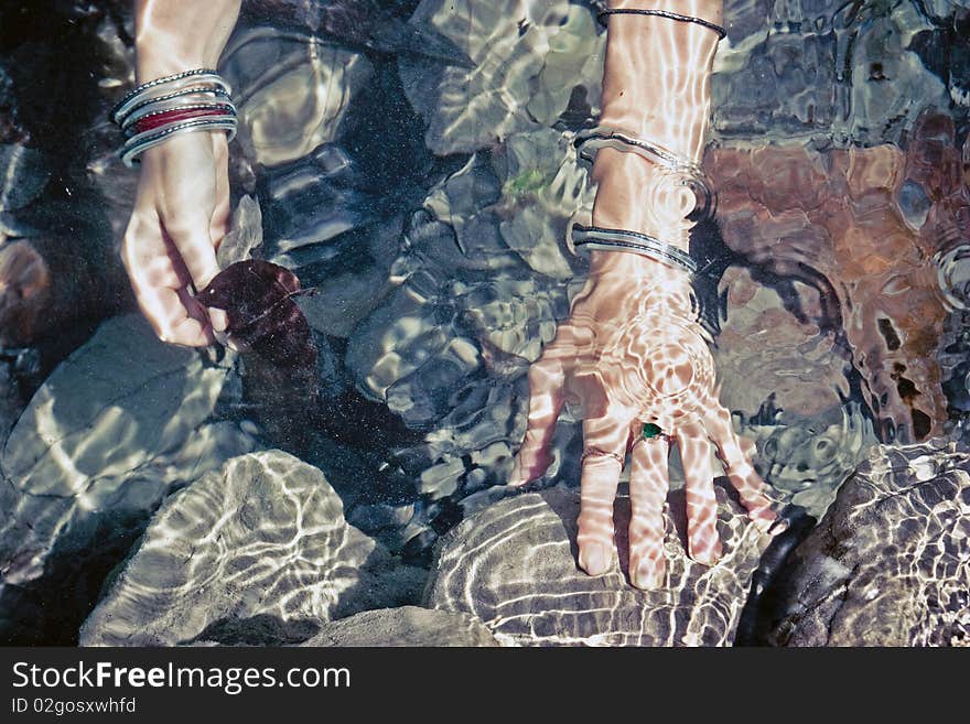 Girls hands under water.