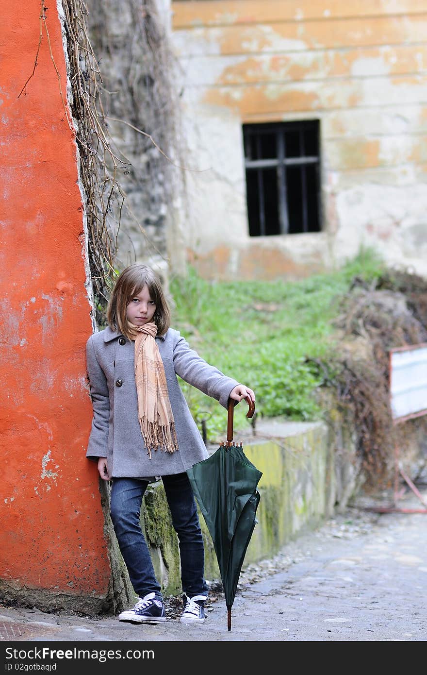 Single child standing near painted old wall. Single child standing near painted old wall