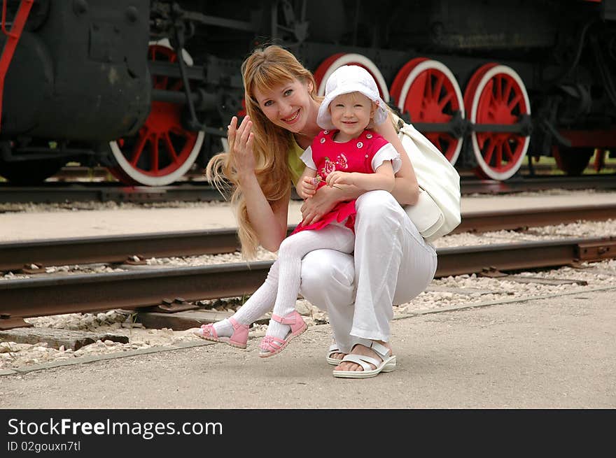 Woman and child beside locomotive