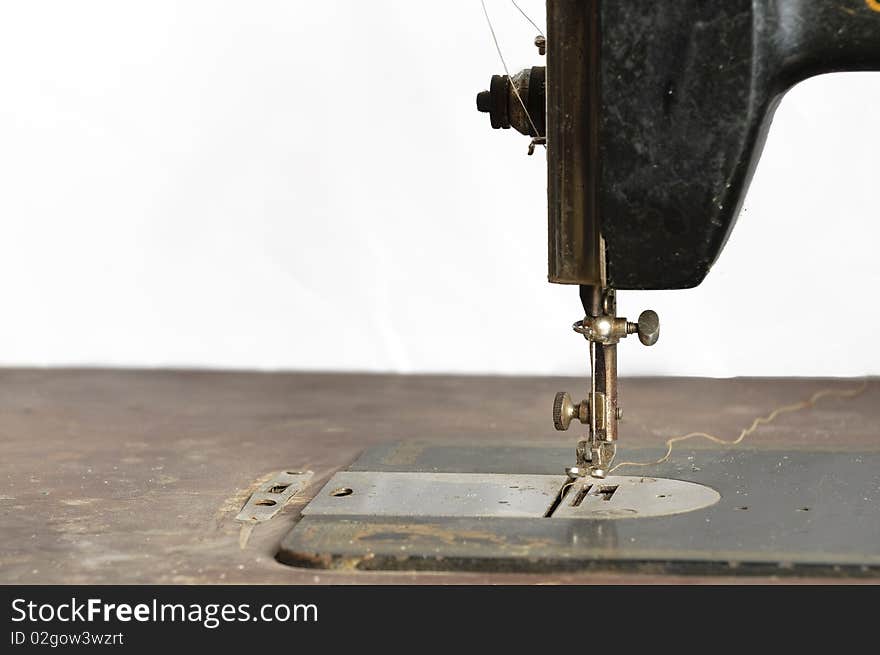 Old black sewing machine on white background