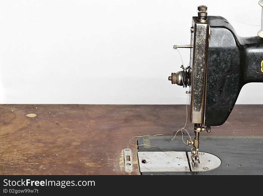 Old black sewing machine on white background