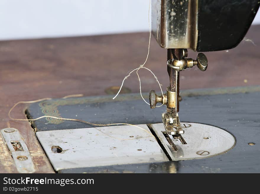 Old black sewing machine on white background