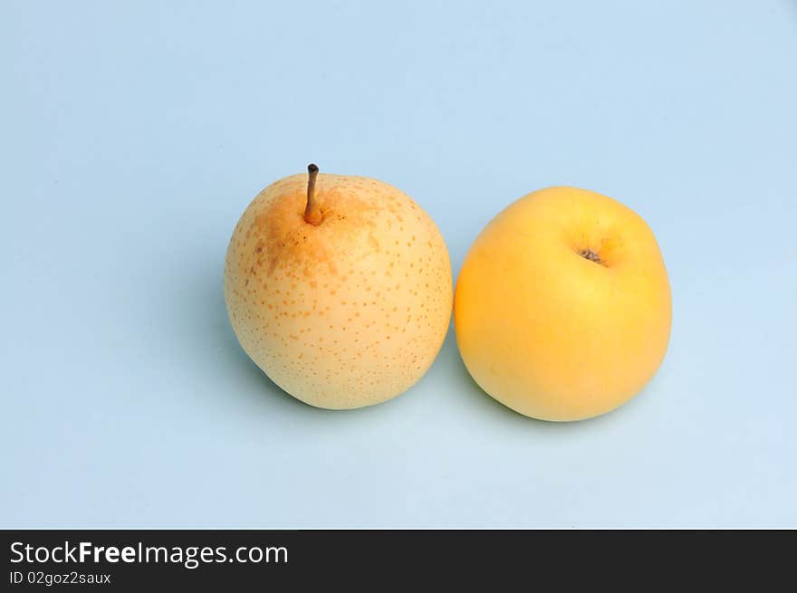 Light blue background of apple, pear. Light blue background of apple, pear.