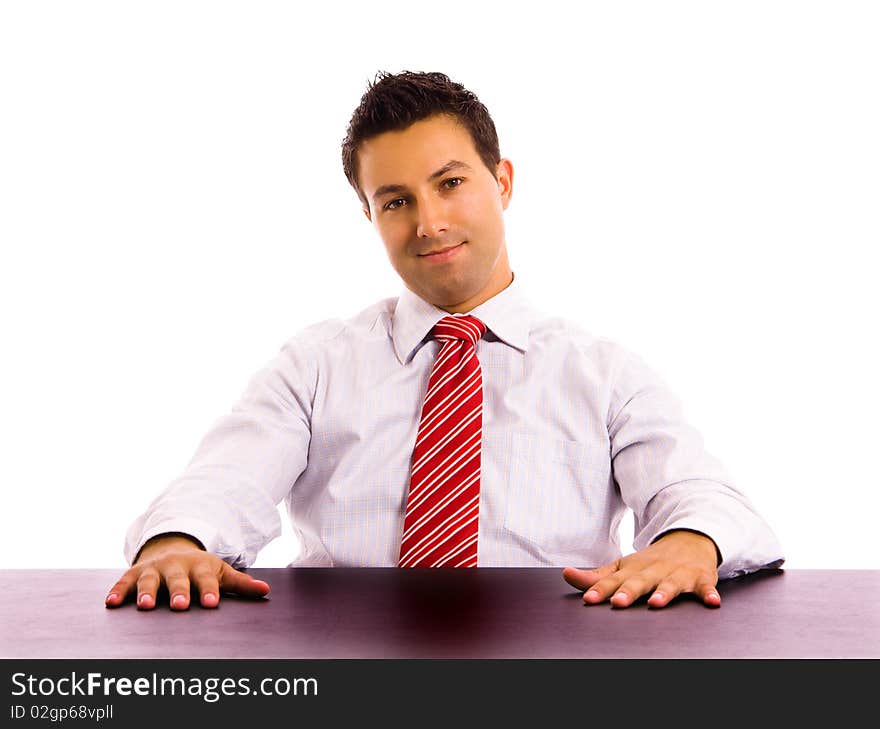 Young business man on a desk, isolated on white