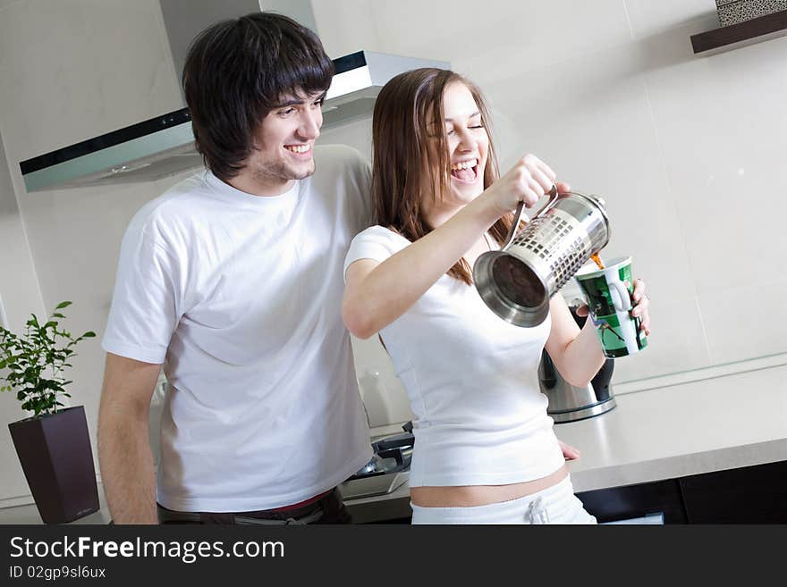 Boy with smile and girl with cup and with teapot. Boy with smile and girl with cup and with teapot