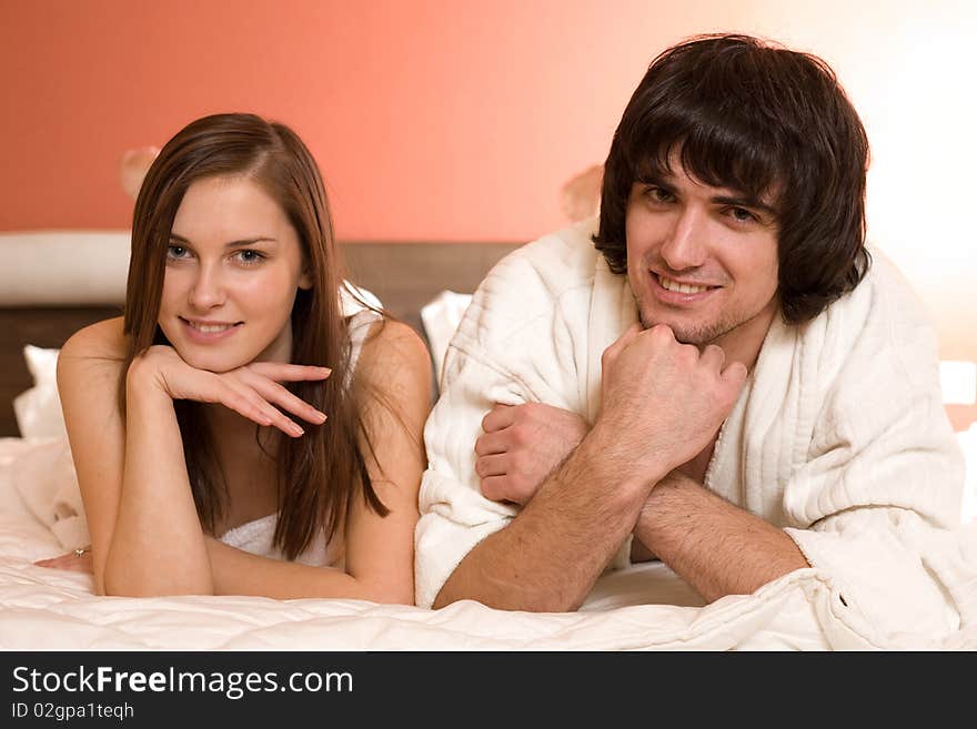 Boy with smile and girl with smile on bed. Boy with smile and girl with smile on bed