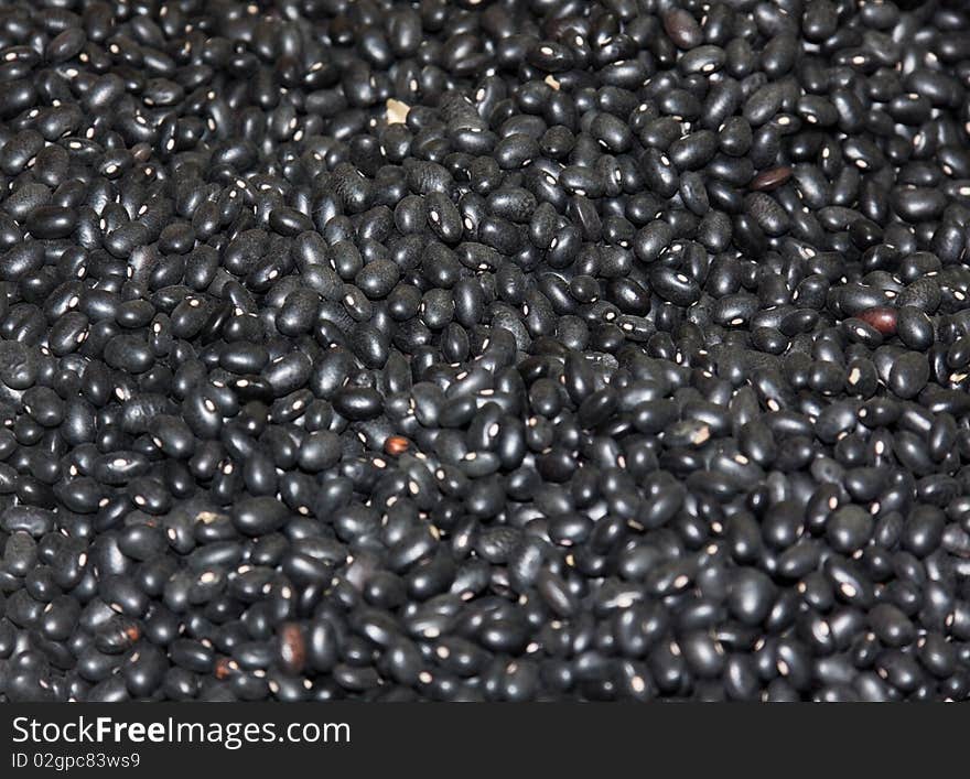 Heap of dried black haricots close-up as background. Heap of dried black haricots close-up as background.