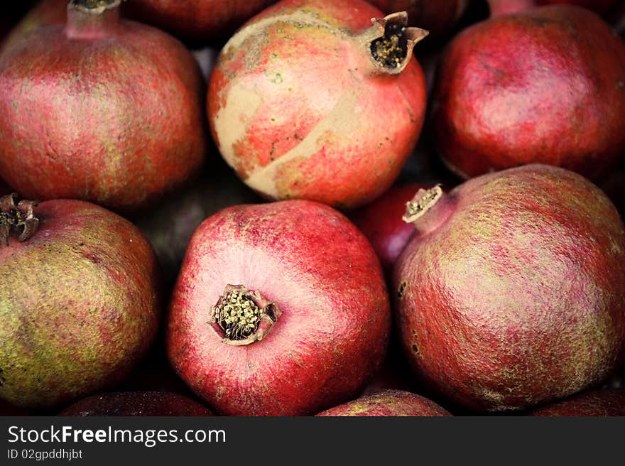 Few red mellow pomegranates in range.