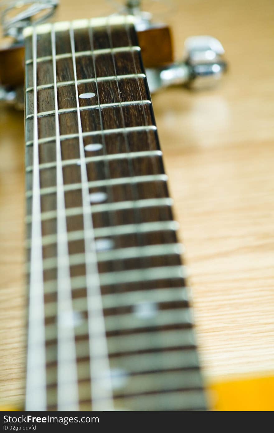 A seven-string acoustic guitar's finger board