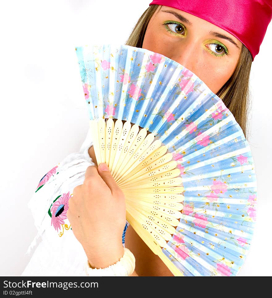 beautiful young girl waving a fan, indoor shoot