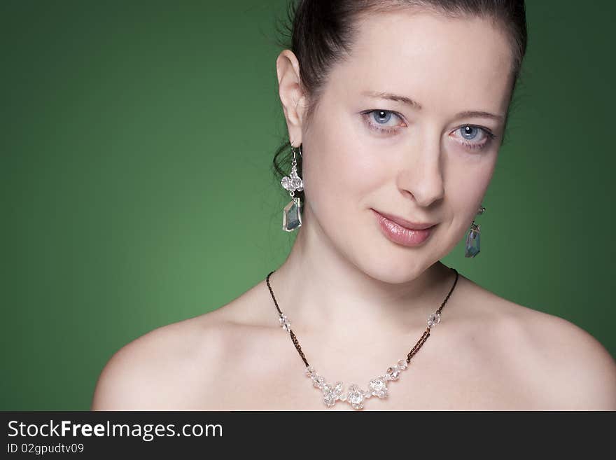 Portrait of a beautiful caucasian young woman with beautiful black hair on green. Portrait of a beautiful caucasian young woman with beautiful black hair on green