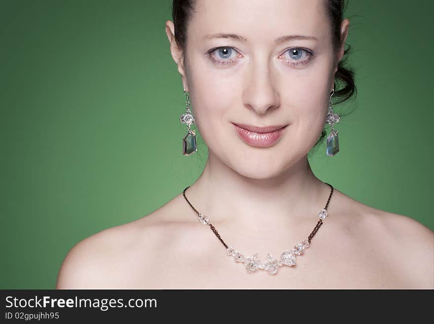 Portrait of a beautiful caucasian young woman with beautiful black hair on green. Portrait of a beautiful caucasian young woman with beautiful black hair on green