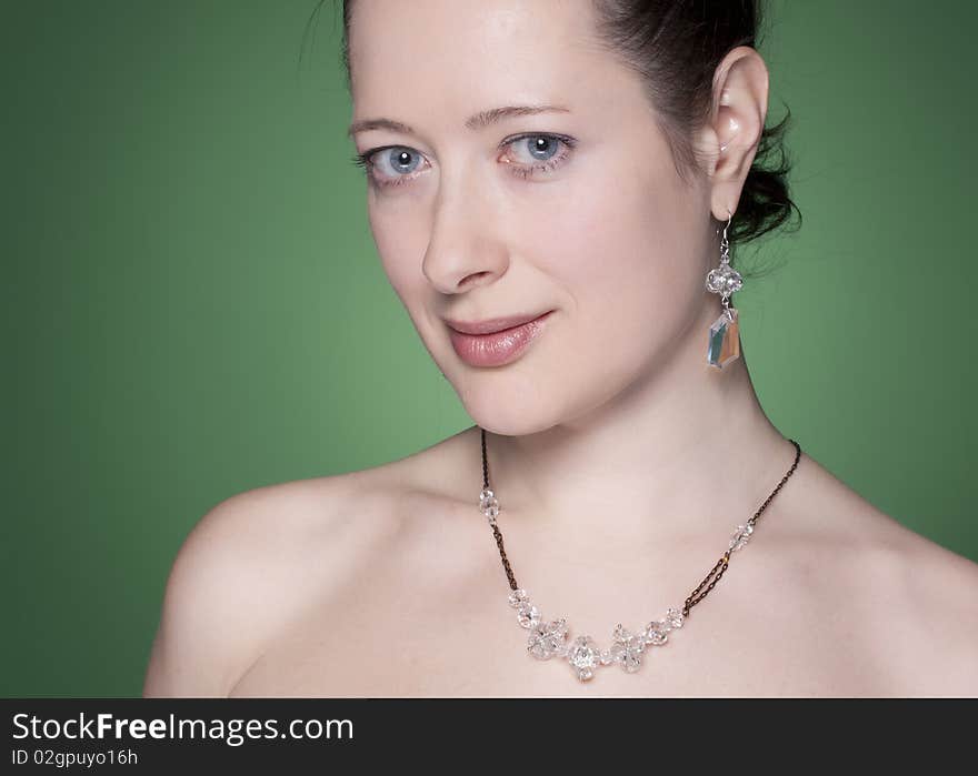 Portrait of a beautiful caucasian young woman with beautiful black hair on green. Portrait of a beautiful caucasian young woman with beautiful black hair on green