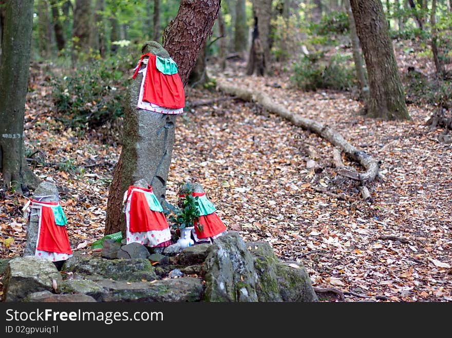 Four kamis with red clothes in the forest