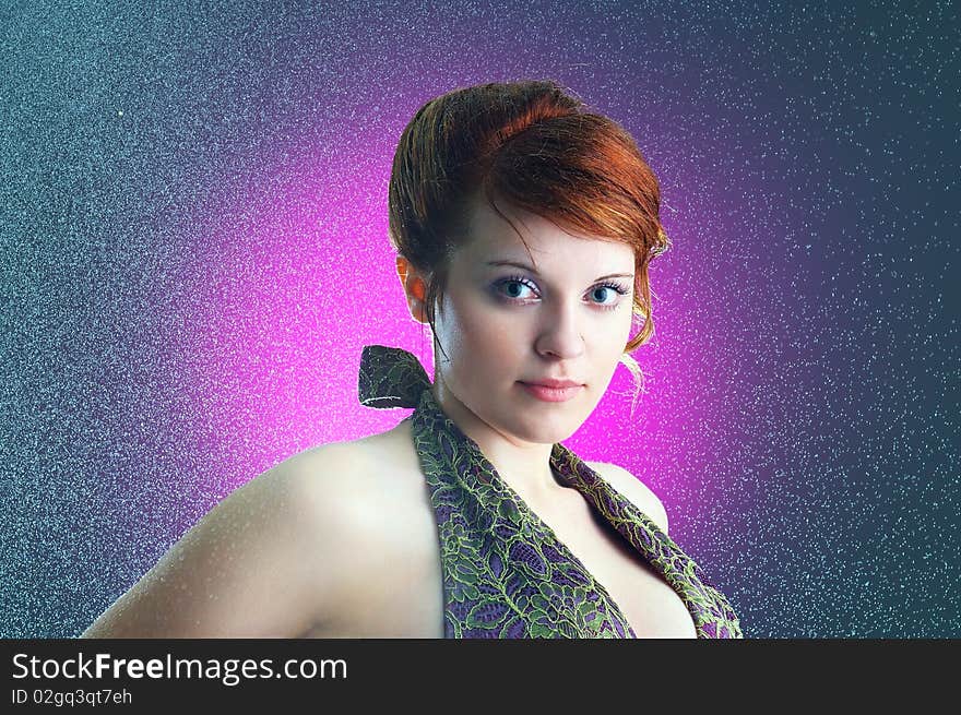 The close-up portrait of a young ginger lady under the rain