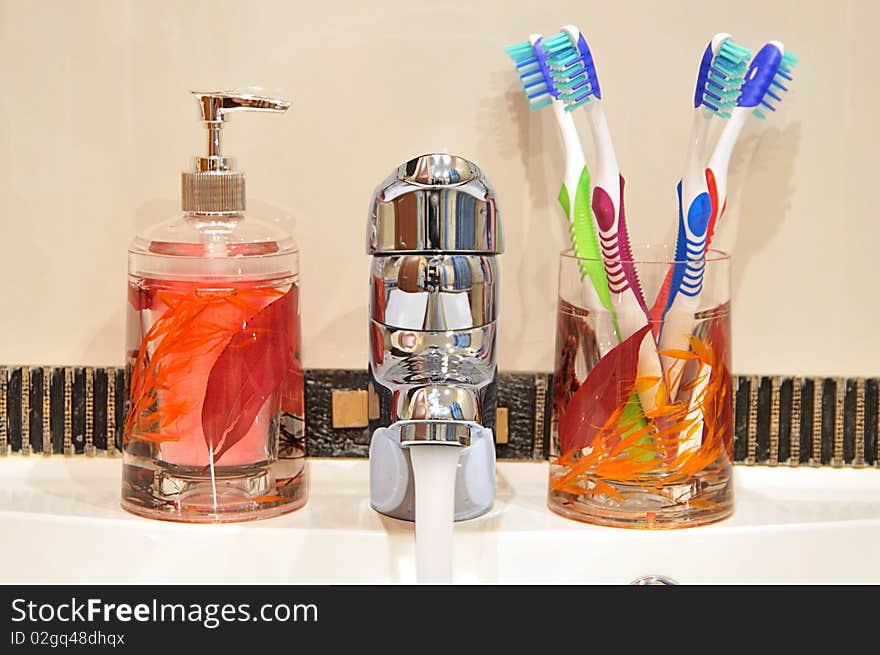 Liquid Soap, Faucet and Four Toothbrushes