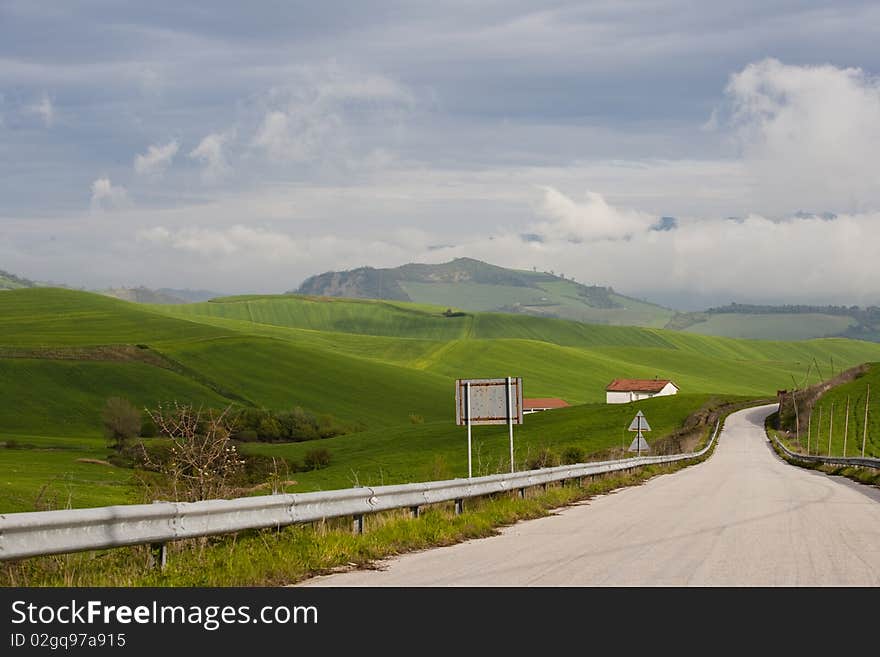 A blue sky with whit clods and green field. A blue sky with whit clods and green field