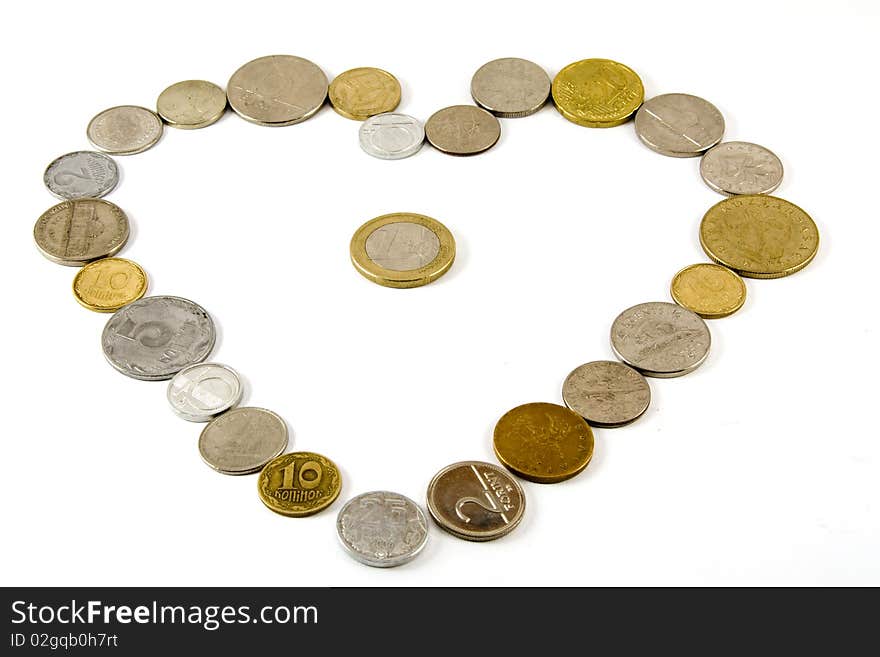 Different countries coins in a shape of a heart with a one euro coin in the middle