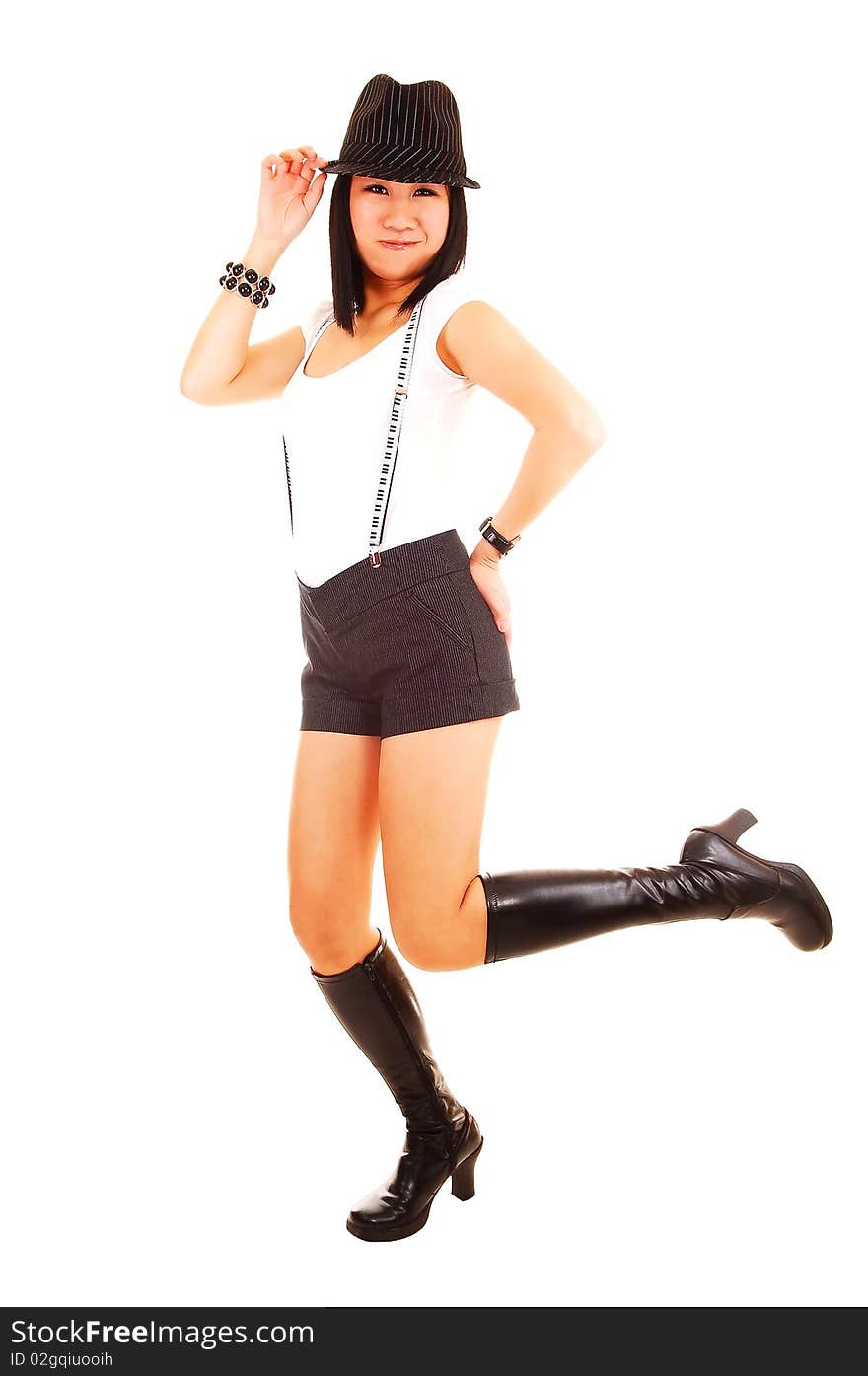 A pretty Asian woman standing on one leg in boots, wearing short shorts, boots with a hat and suspender and white top, for white background. A pretty Asian woman standing on one leg in boots, wearing short shorts, boots with a hat and suspender and white top, for white background.