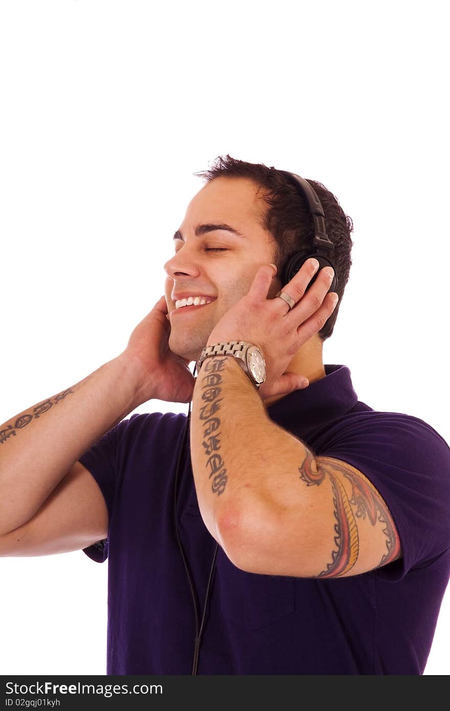 Handsome latino male listening to music with headphones.