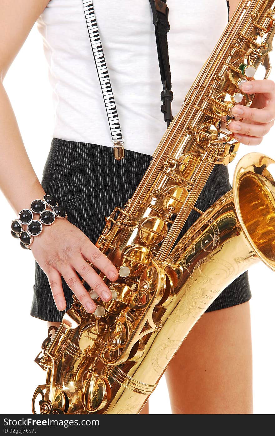 A young Asian woman standing in the studio, playing the saxophone in shorts with suspender, in closeup, for white background. A young Asian woman standing in the studio, playing the saxophone in shorts with suspender, in closeup, for white background.