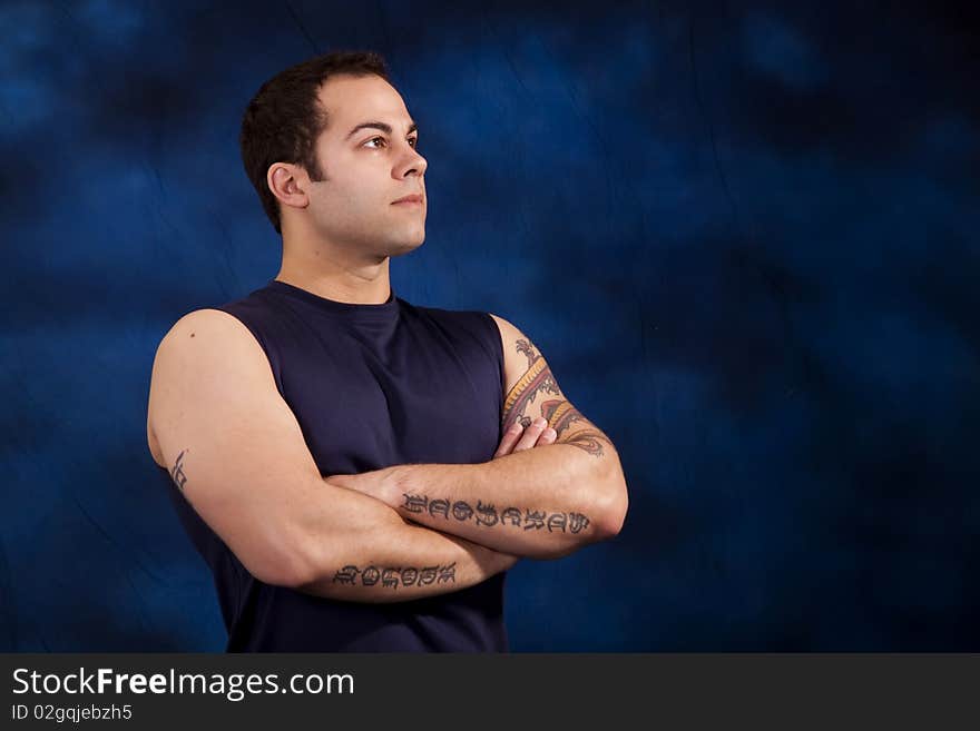 Hispanic man showing off his huge bicep muscles. Hispanic man showing off his huge bicep muscles.