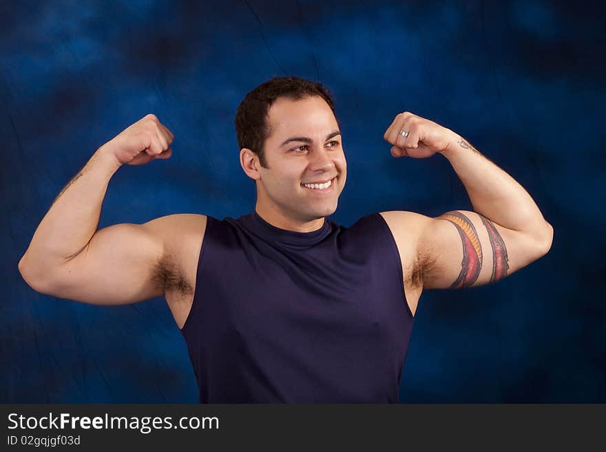 Hispanic man showing off his huge bicep mucles. Hispanic man showing off his huge bicep mucles.