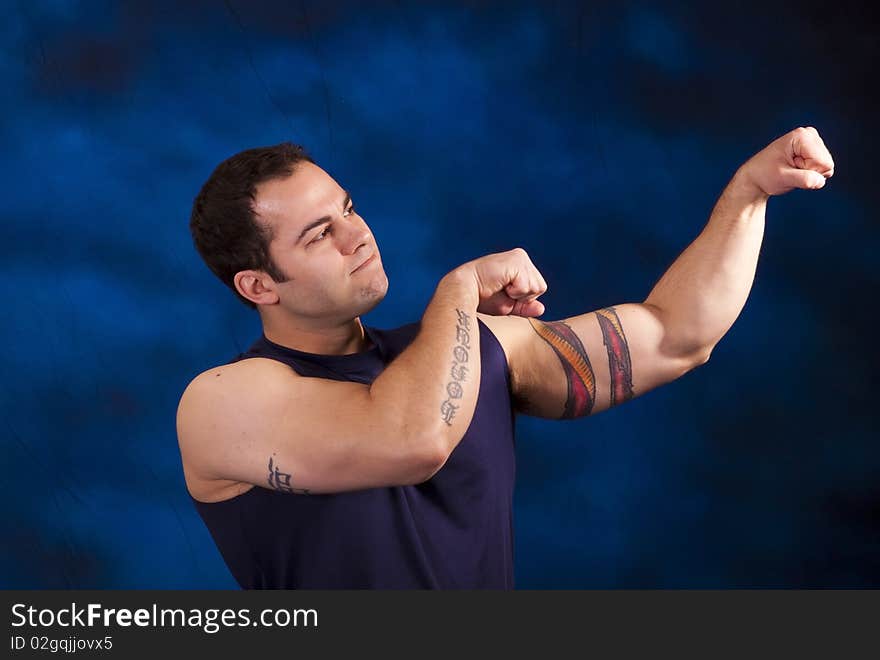 Hispanic man with large bicep muscles. Hispanic man with large bicep muscles