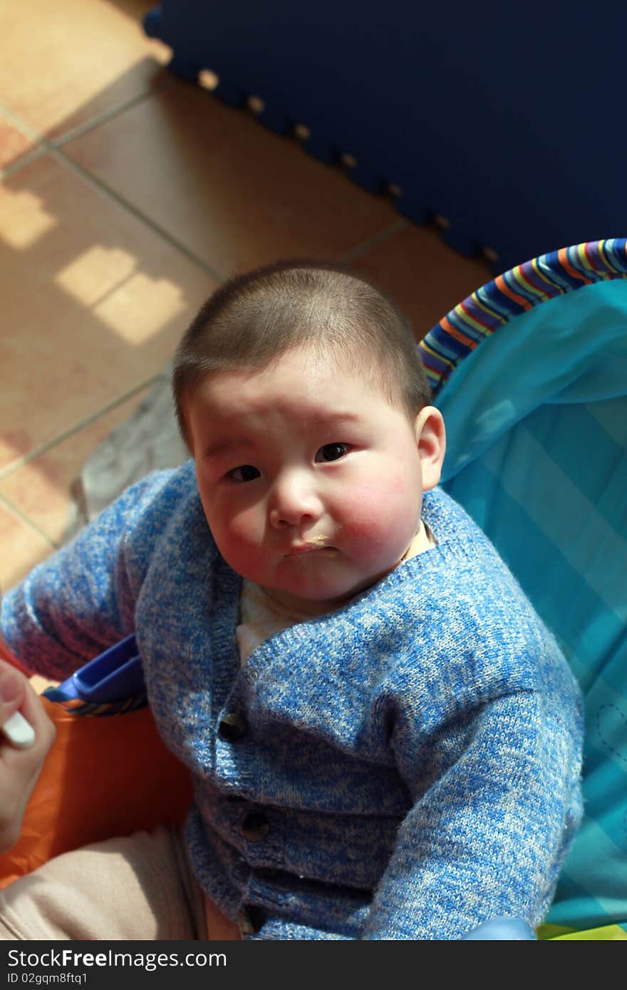 Lovely Chinese baby sitting in the sunshine. Lovely Chinese baby sitting in the sunshine