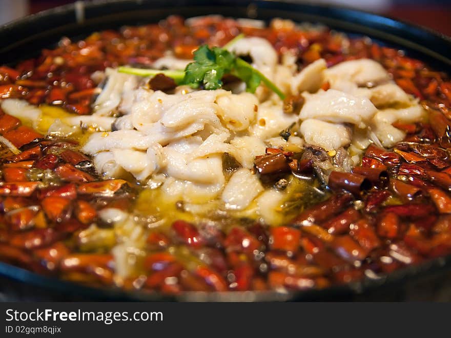 Pepper and fish in a wblack plate,taken in china. Pepper and fish in a wblack plate,taken in china