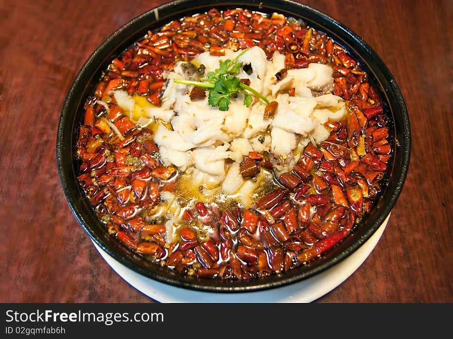 Pepper and fish in a wblack plate,taken in china. Pepper and fish in a wblack plate,taken in china