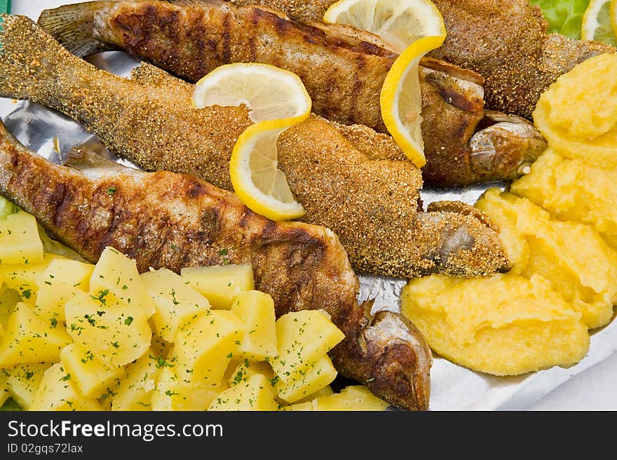 Tasty grilled fish and potatoes. Tasty grilled fish and potatoes