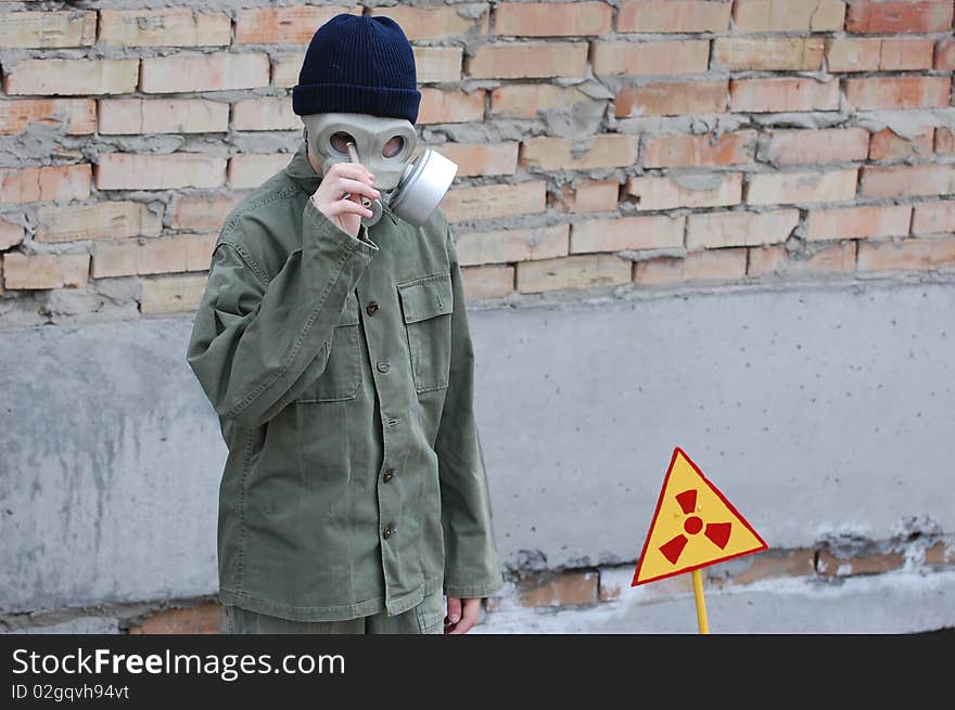 Teenager weared American military uniform.Lost city. Near Chernobyl area. Modern ruins. Ukraine. Kiev region. Teenager weared American military uniform.Lost city. Near Chernobyl area. Modern ruins. Ukraine. Kiev region