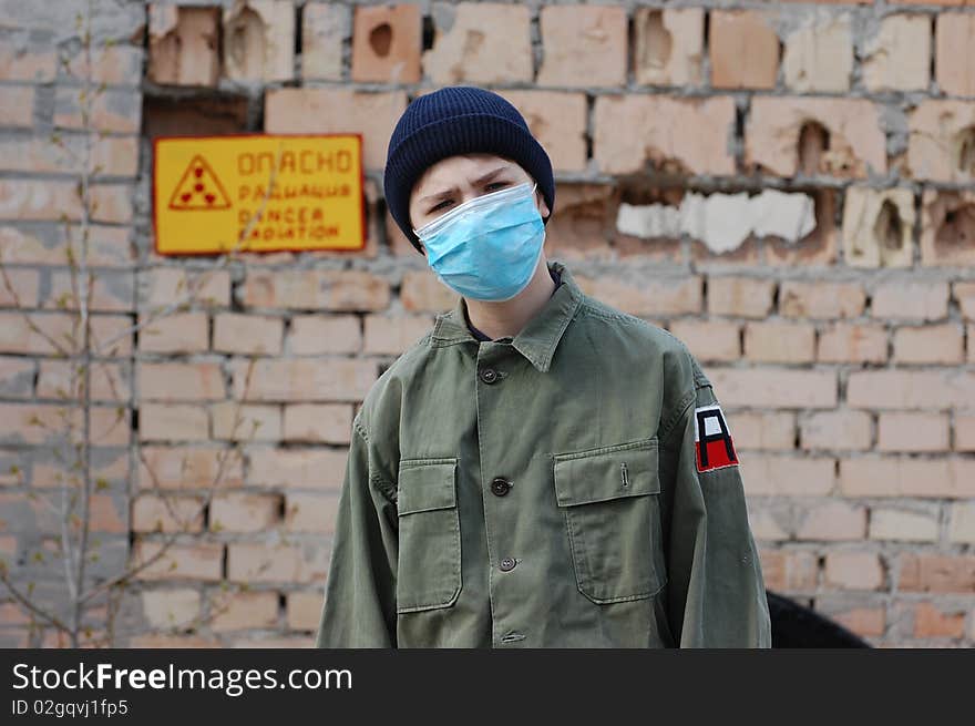 Teenager weared American military uniform.Lost city. Near Chernobyl area. Modern ruins. Ukraine. Kiev region. Teenager weared American military uniform.Lost city. Near Chernobyl area. Modern ruins. Ukraine. Kiev region