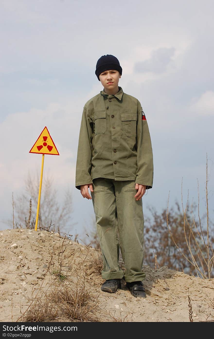 Teenager weared American military uniform.Lost city. Near Chernobyl area. Modern ruins. Ukraine. Kiev region. Teenager weared American military uniform.Lost city. Near Chernobyl area. Modern ruins. Ukraine. Kiev region